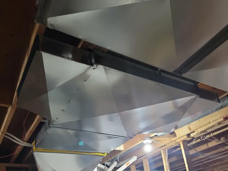 Custom sheet metal plenum and transition fittings for a Kitchener-Waterloo HVAC installation