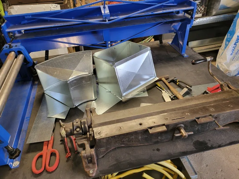 Galvanized steel sheet being cut on a shear for ductwork