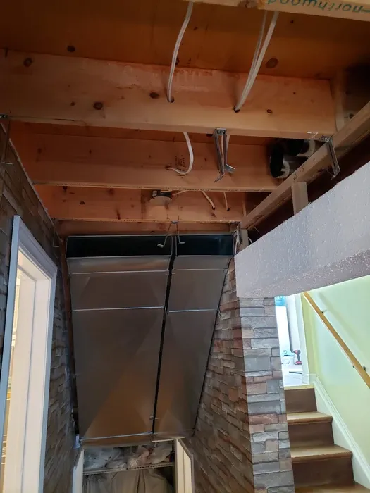 Rigid sheet metal branch run connected to a main trunk line