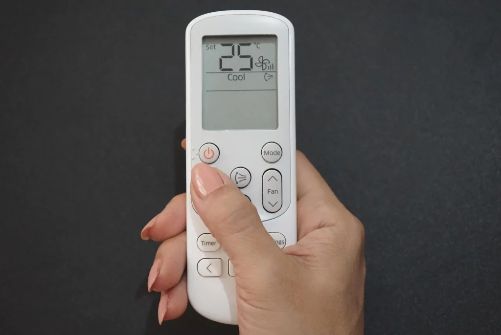Air Conditioning Unit Remote being held
