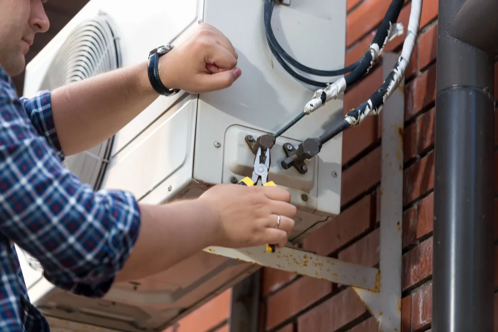 An HVAC tech working on a Kitchener air conditioning system