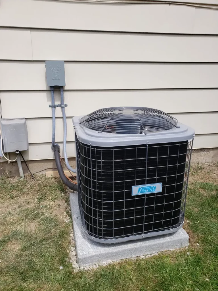 An outdoor AC unit in Kitchener on the side of a house