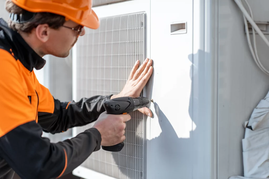HVAC Tech installing air conditioner in Kitchener