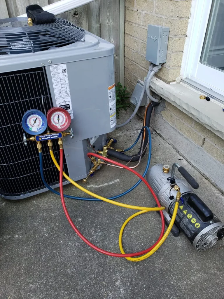 An air conditioning unit being repaired in Kitchener on a residential home