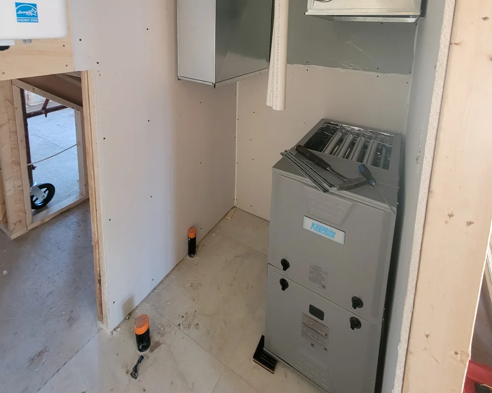 New high-efficiency KeepRite furnace installation in Kitchener Ontario, showing proper sizing and placement for residential HVAC system.